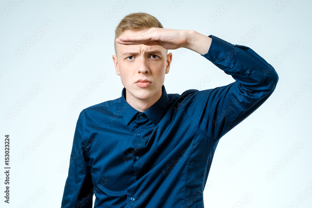Young man looking far away isolated on white Young man looking far away isolated on white
