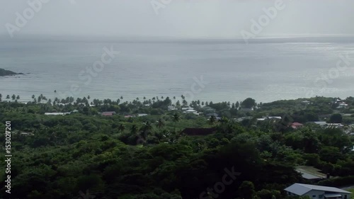 Elevated pan across of Bacolet Bay from view point at Fort King George in Scarborough, Tobago photo