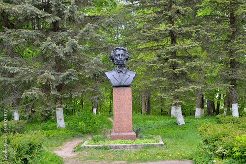 Bust monument to A. S. Pushkin among the firs photo