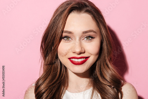 Smiling young brunette lady looking at camera