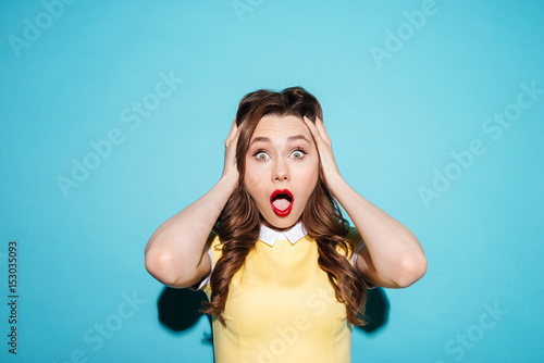 Portrait of a surprised shocked woman in dress