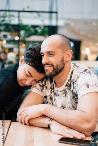 A man and a woman are sitting in a cafe