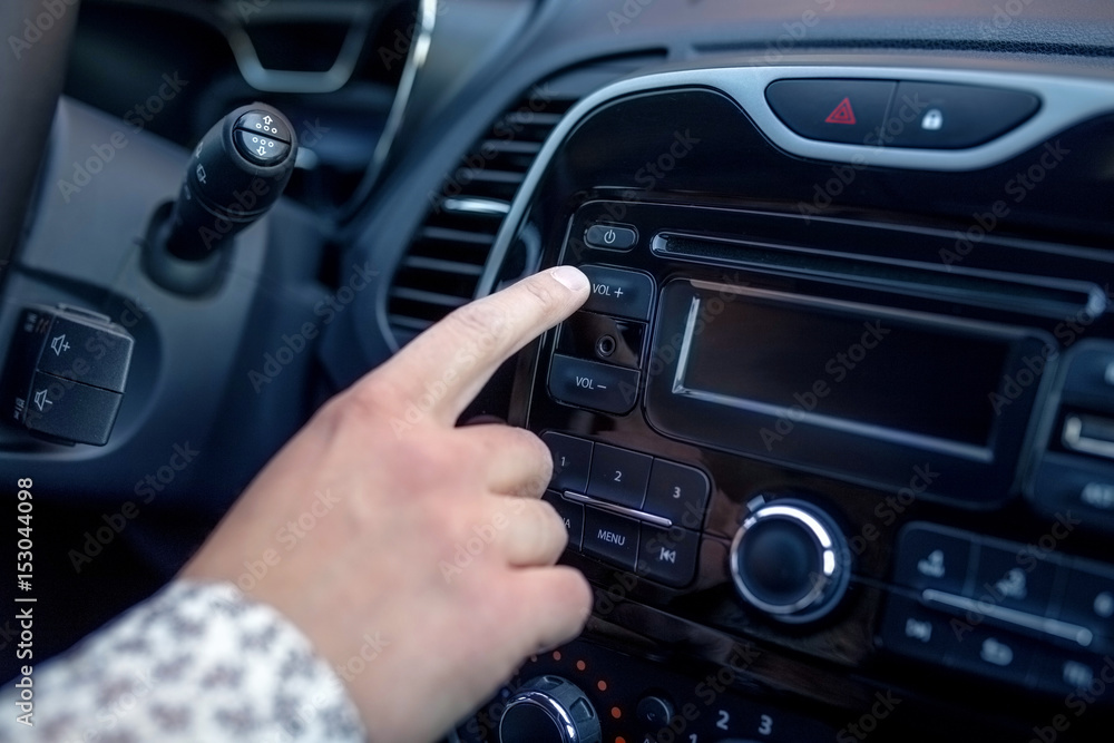 A man Pressing Button On Dashboard While Driving Car A man Pressing Button On Dashboard While Driving Car