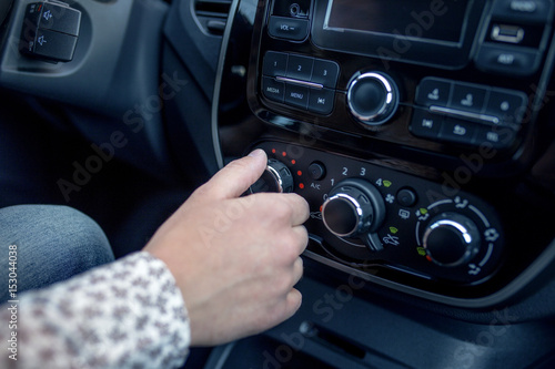 Male hand pressing button in modern car