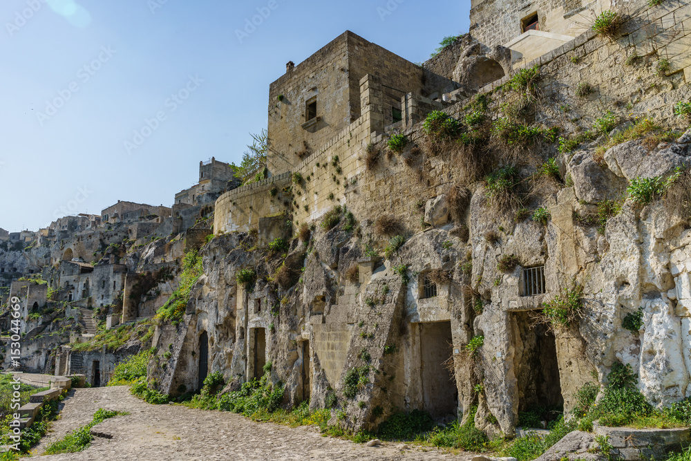 beautiful ancient ghost town of Matera (Sassi di Matera) in beautiful bright sun shine with blue sky, south Italy.