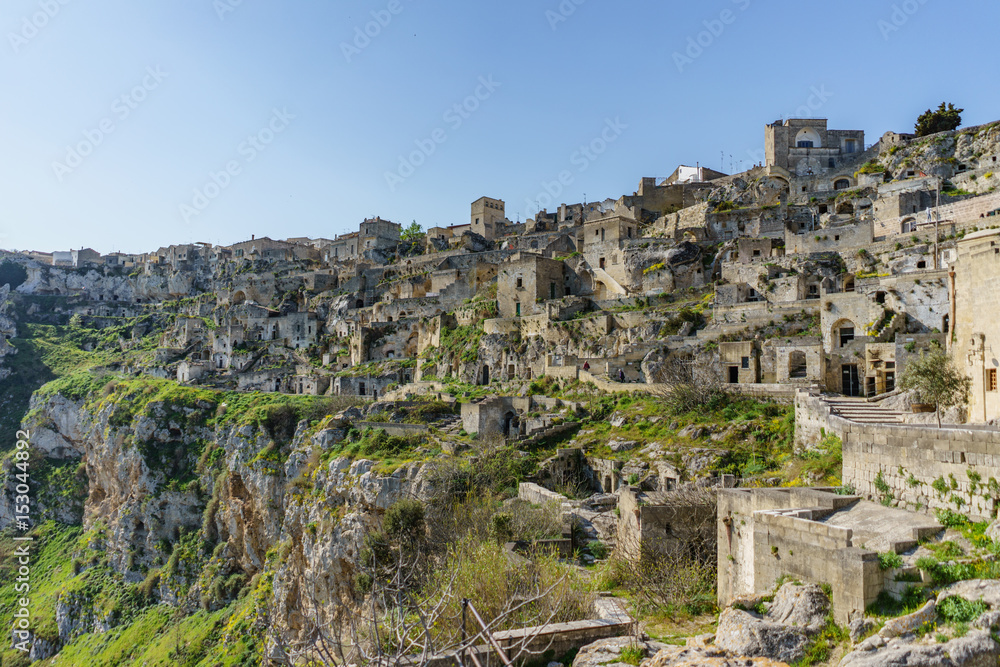 beautiful ancient ghost town of Matera (Sassi di Matera) in beautiful bright sun shine with blue sky, south Italy