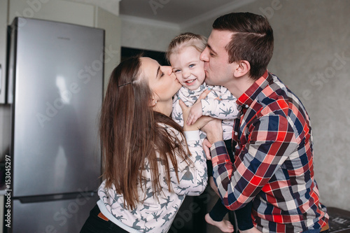 Mom, Dad and little girl having fun together