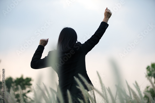 business woman with cheerful acting in reeds grass field background.