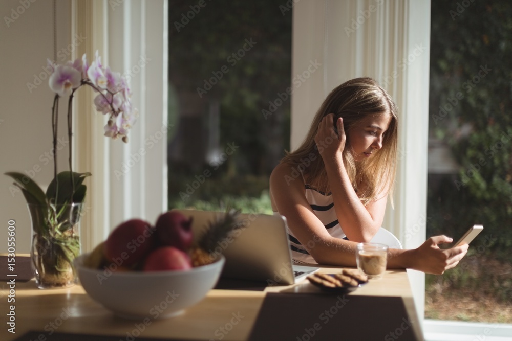 Beautiful woman using mobile phone at home Beautiful woman using mobile phone at home