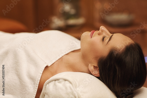 Gorgeous young woman relaxing at luxury spa center
