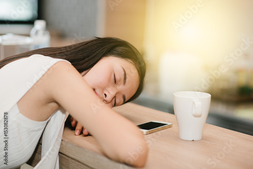 Woman sleeping on a table in a coffee shop