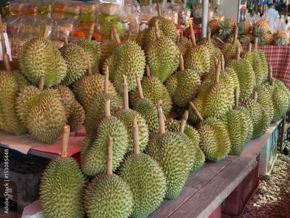RAYONG, THAILAND-APRIL, 2017 : Group of ripe Durian on wood Shelf at fruit market shop, Rayong, Thailand. RAYONG, THAILAND-APRIL, 2017 : Group of ripe Durian on wood Shelf at fruit market shop, Rayong, Thailand.