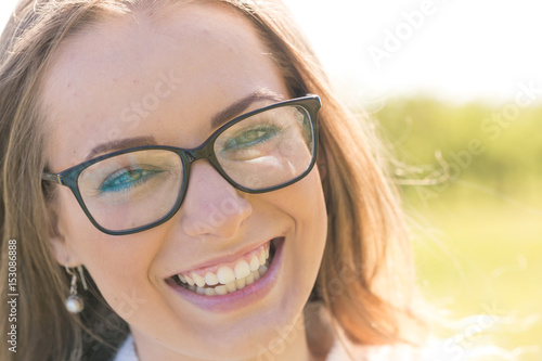 Wallpaper Mural Woman smiling with perfect smile and white teeth in a park and looking at camera Torontodigital.ca