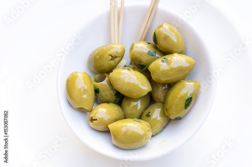 green olives in white bowl on table