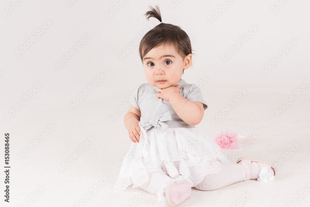 Princess little girl sitting on the floor with her tutu and pink crawn Princess little girl sitting on the floor with her tutu and pink crawn