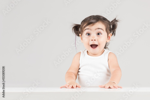Happy and surprised child girl with excited expression photo
