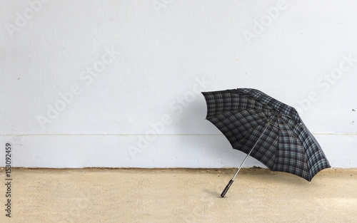 happy rainy day concept. umbrella with brick wall background