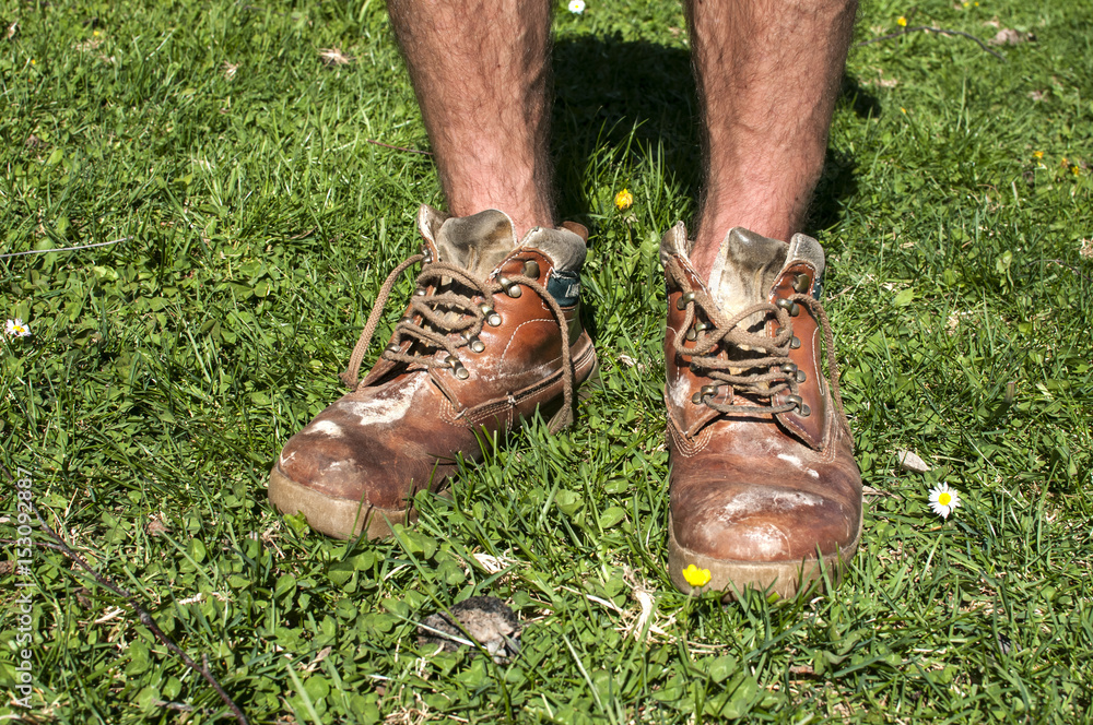 Man legs in old used weathered moldy grunge leather shoes on green grass  field Stock Photo | Adobe Stock