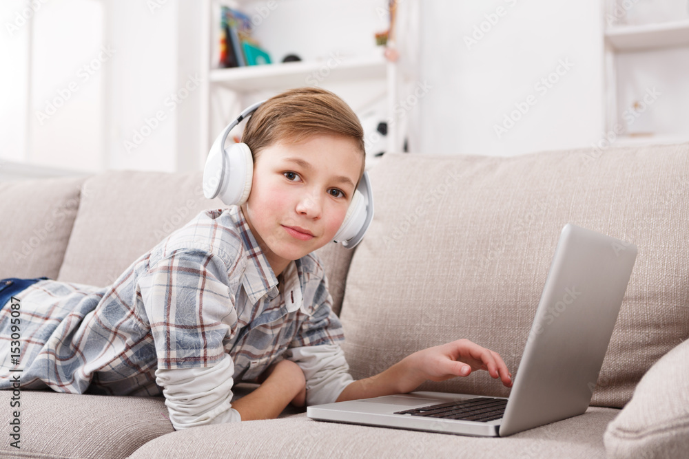 Teenage boy enjoying music in headphones at home Teenage boy enjoying music in headphones at home