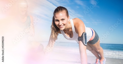 Smiling woman exercising at beach