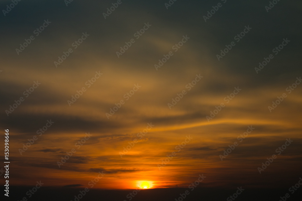 Beautiful blazing sunset landscape at black sea and orange sky above it with awesome sun golden reflection on calm waves as a background. Amazing summer sunset view on the beach