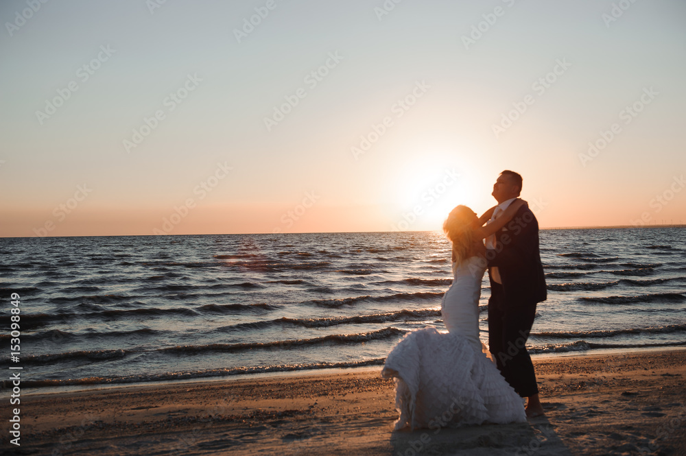 Just Married. Beautiful young couple on the beach at sunset