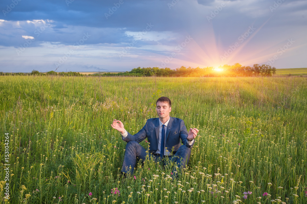 Fototapeta premium Peaceful businessman sitting in lotus pose