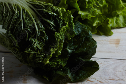 Green Pekinese cabbage on a white wooden background. Healthy food. Healthy food.