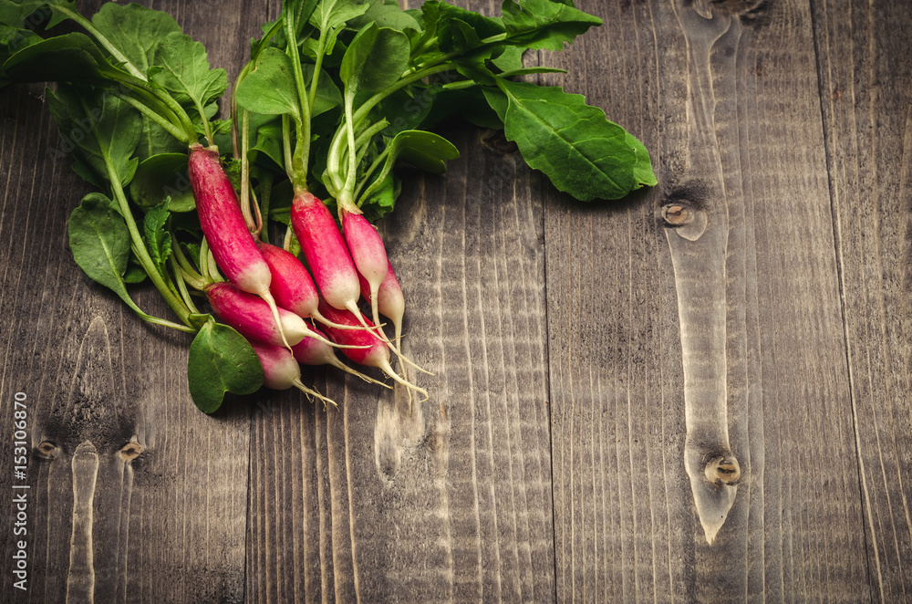 bunch garden radish on a wooden background/radish bunch on a dark wooden background bunch garden radish on a wooden background/radish bunch on a dark wooden background