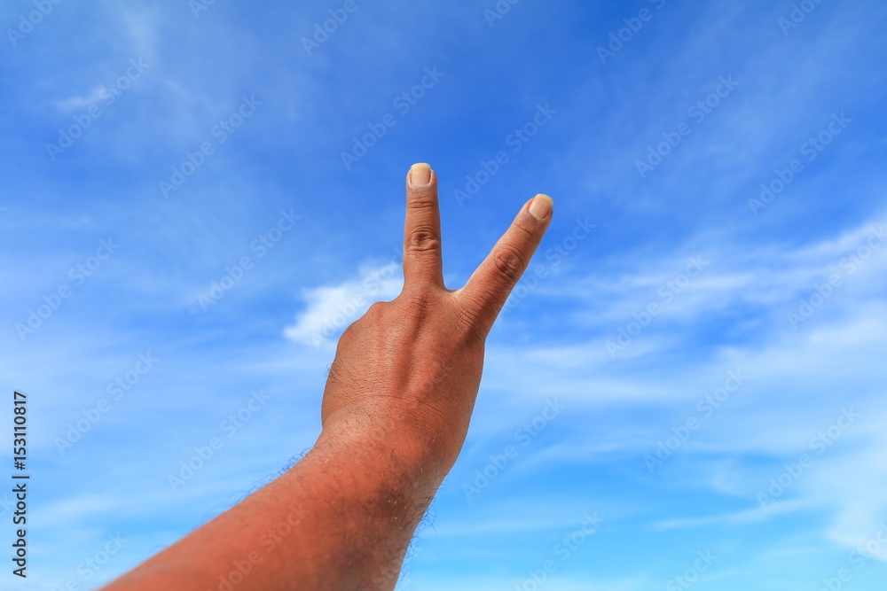 hand show counting number two on sky background hand show counting number two on sky background