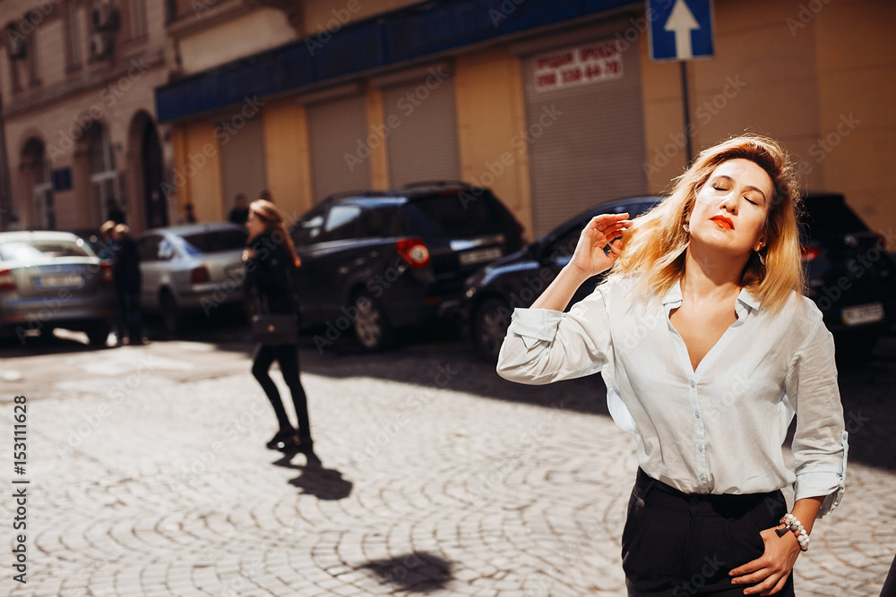 The charming lady standing on the street The charming lady standing on the street