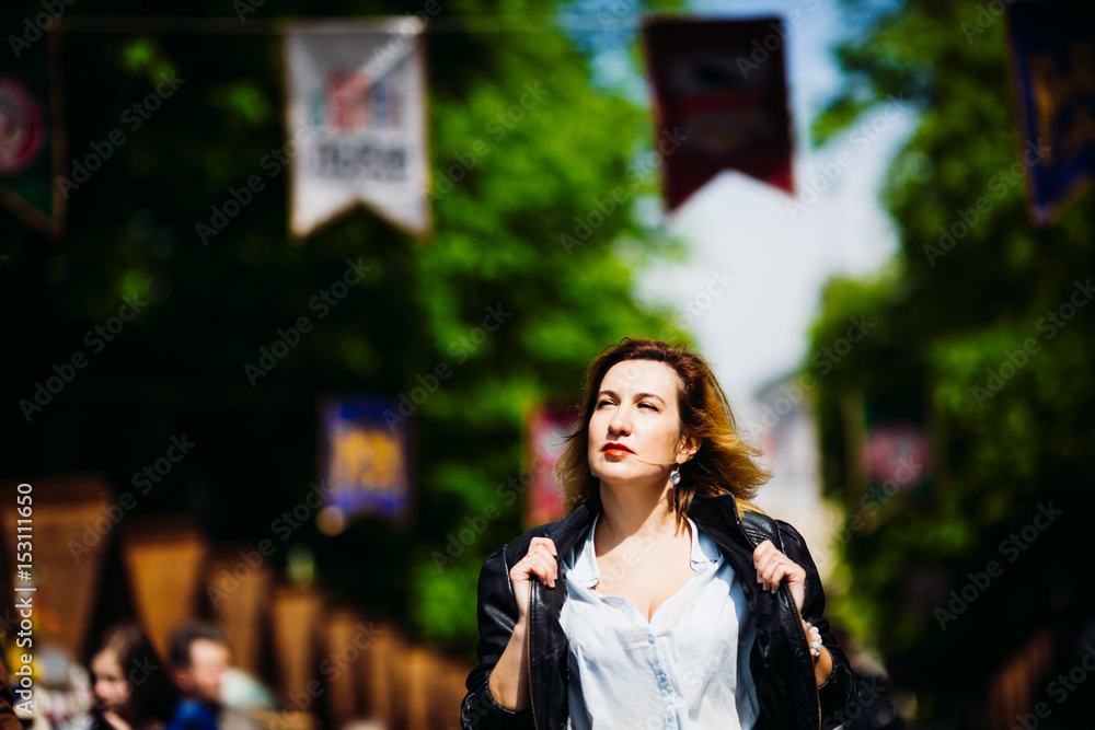 The stylish girl walking along street