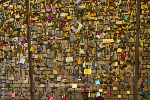 Love locks from a bridge in Italy representing secure friendship and romance