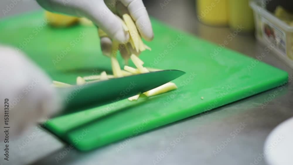 Hand Cutting The Potatoes In The Kitchen Hand Cutting The Potatoes In The Kitchen