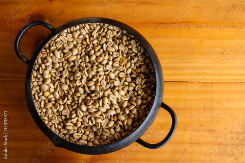 The yellow dry coffee beans in bowl. 
