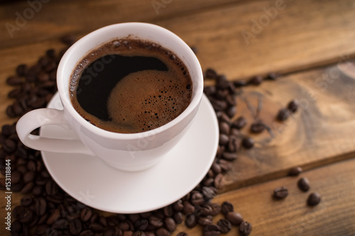cup of black coffee on wooden background