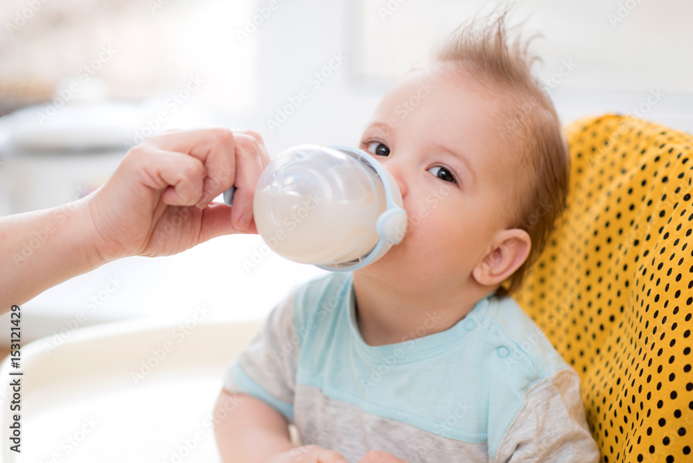 Grandmother gives the baby a fruit compote Grandmother gives the baby a fruit compote