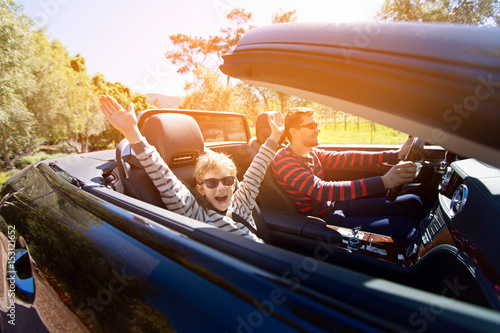 family in convertible car