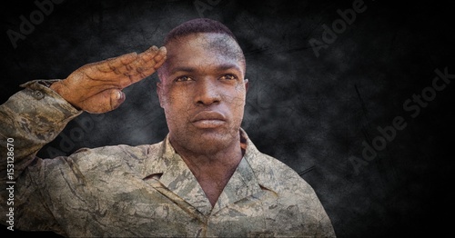 Soldier saluting with black grunge background
