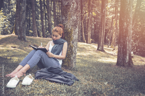 Women write notes Nature trails, mountains, forests. Writer