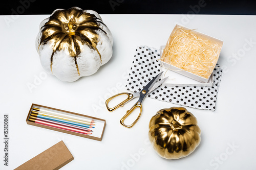 Halloween decor on white table over black background.