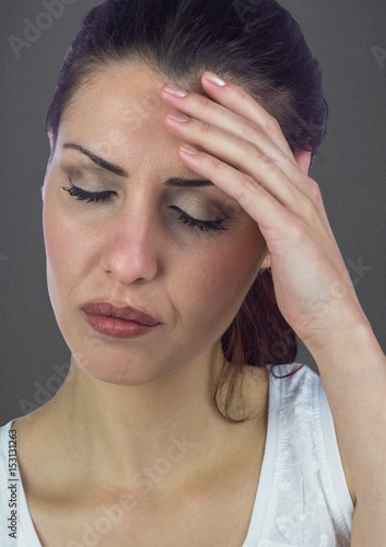 Stressed woman against grey wall