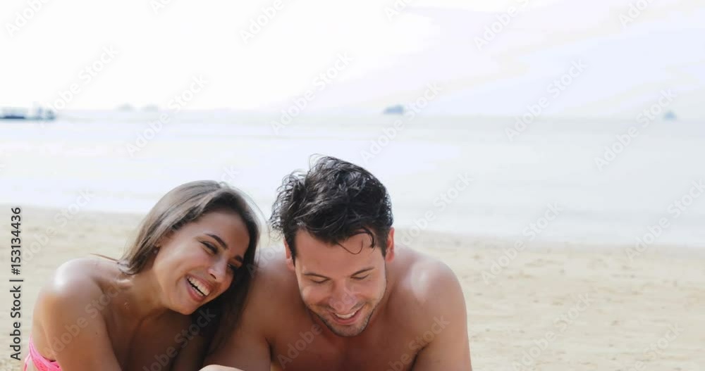 Couple Lying On Beach Using Cell Smart Phone Talking, Young Man And Woman On Seashore Tourists On Summer Vacation Slow Motion 60 Couple Lying On Beach Using Cell Smart Phone Talking, Young Man And Woman On Seashore Tourists On Summer Vacation Slow Motion 60