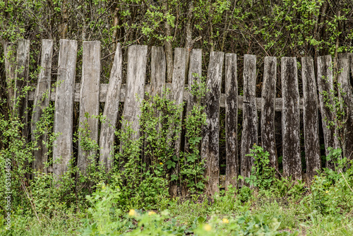 Wooden rotting old fence in the village