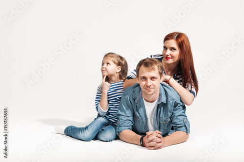 Happy funny family portrait lying on white background isolated