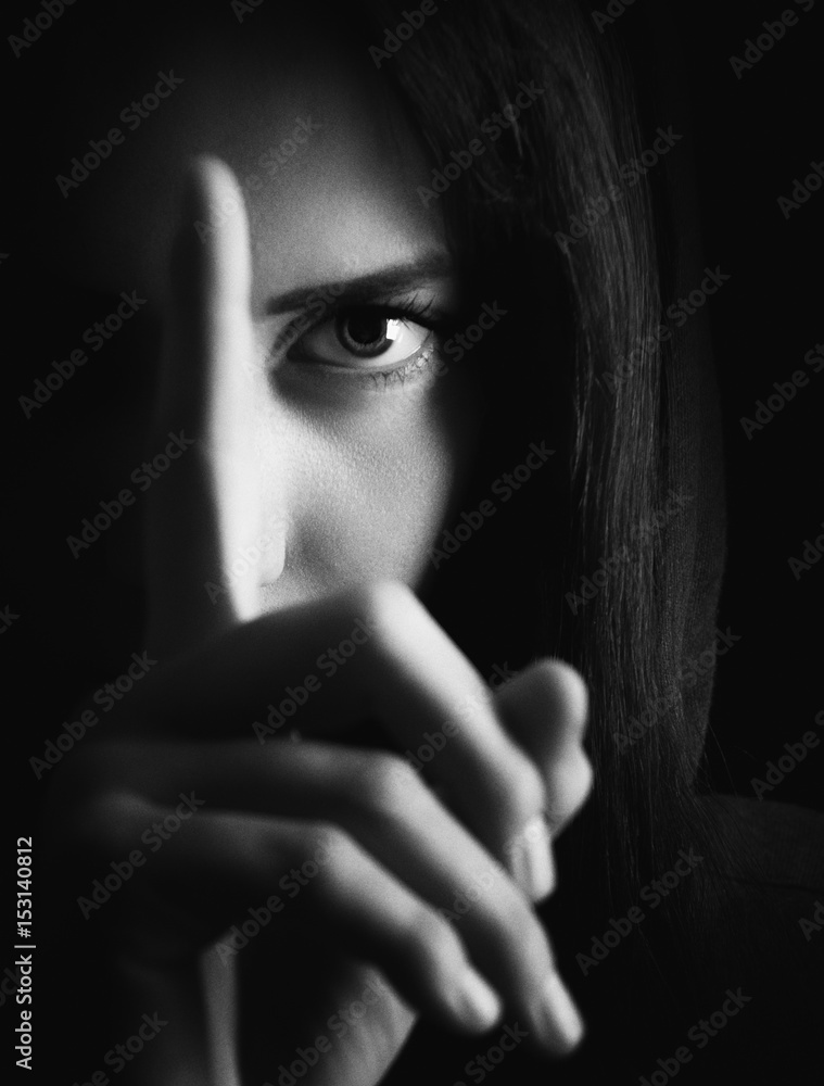 Girl shows index finger in front of face,black and white Girl shows index finger in front of face,black and white