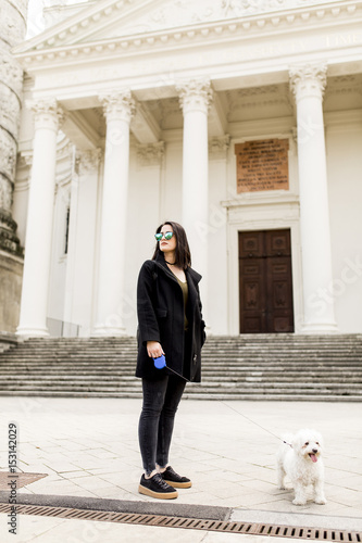 Woman walking with a dog on...