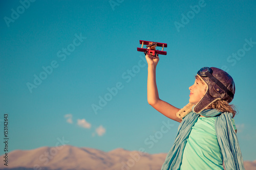 Happy child playing with toy airplane