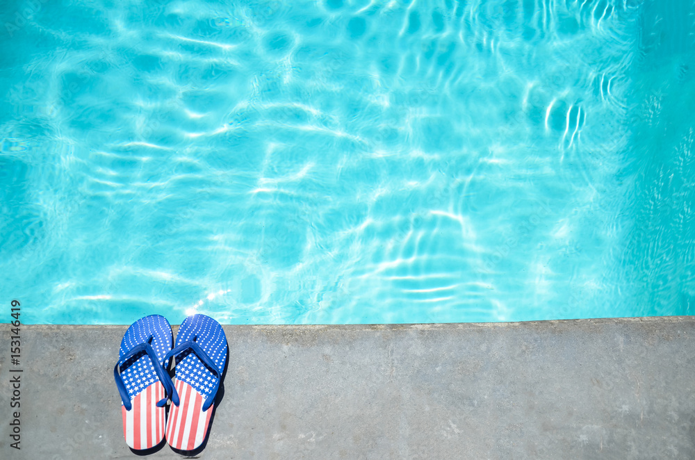Naklejka premium Summer background with flip flops near the pool
