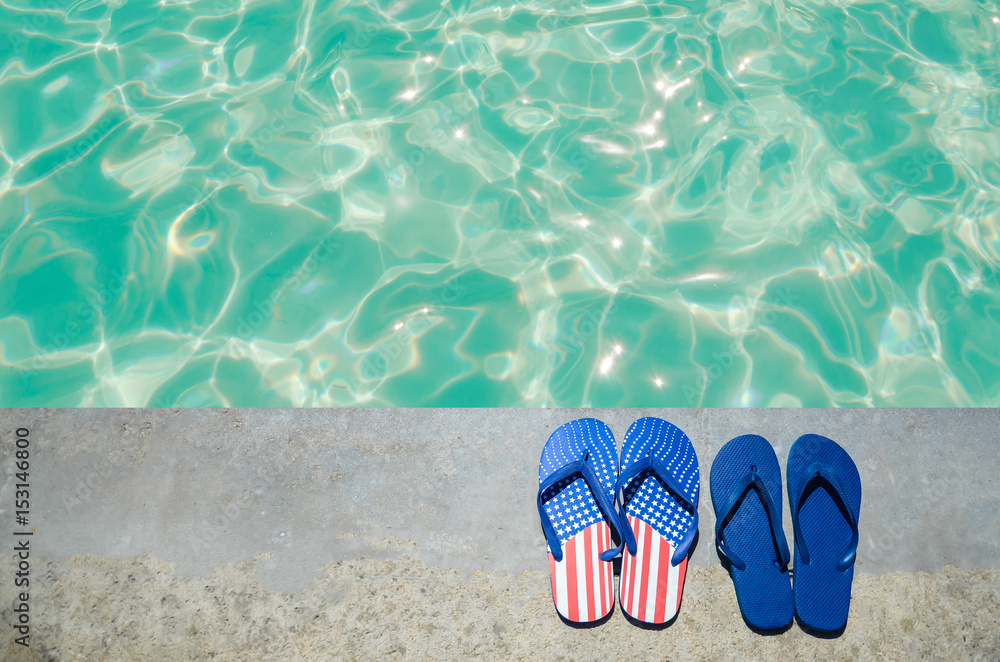 Naklejka premium Summer background with flip flops near the pool